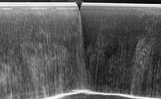 Flow of water in a big fountain, black and white